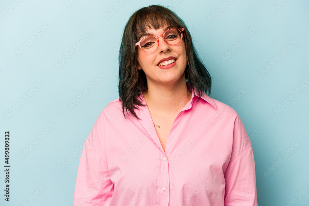 Young caucasian woman isolated on blue background happy, smiling and cheerful. Young caucasian woman isolated on blue background happy, smiling and cheerful.