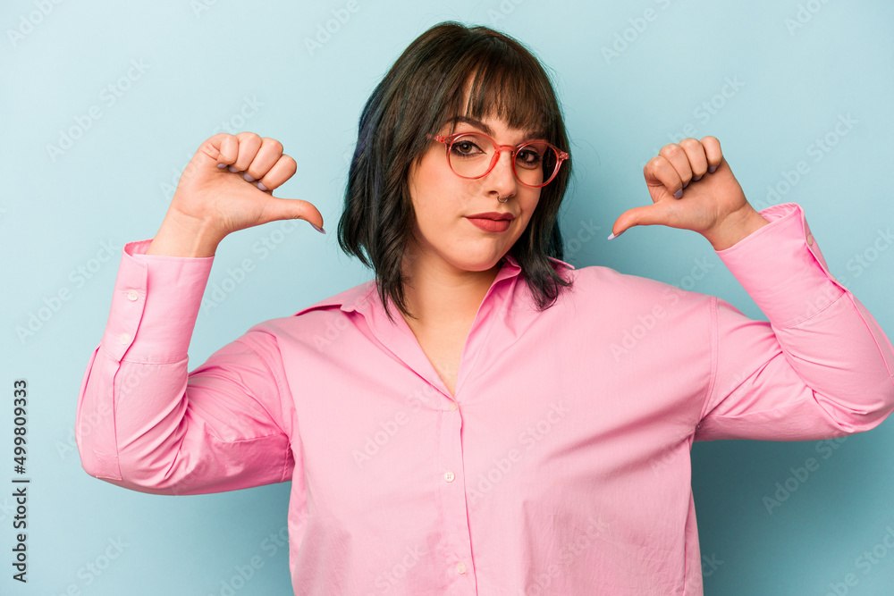 Young caucasian woman isolated on blue background feels proud and self confident, example to follow. Young caucasian woman isolated on blue background feels proud and self confident, example to follow.
