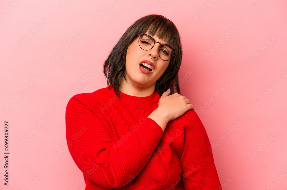 Young caucasian woman isolated on pink background having a shoulder pain. Young caucasian woman isolated on pink background having a shoulder pain.