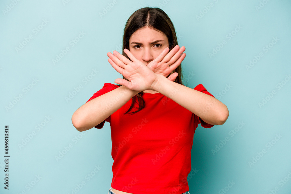 Young caucasian woman isolated on blue background doing a denial gesture Young caucasian woman isolated on blue background doing a denial gesture