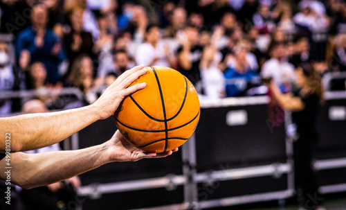 referee holding  basketball during game