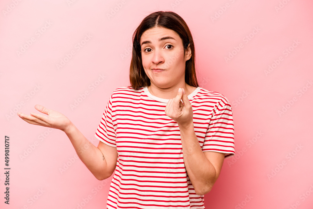 Young caucasian woman isolated on pink background showing that she has no money. Young caucasian woman isolated on pink background showing that she has no money.