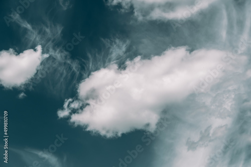 Blue sky with puffy clouds for background. Atmospheric phenomena in formation of precipitation.