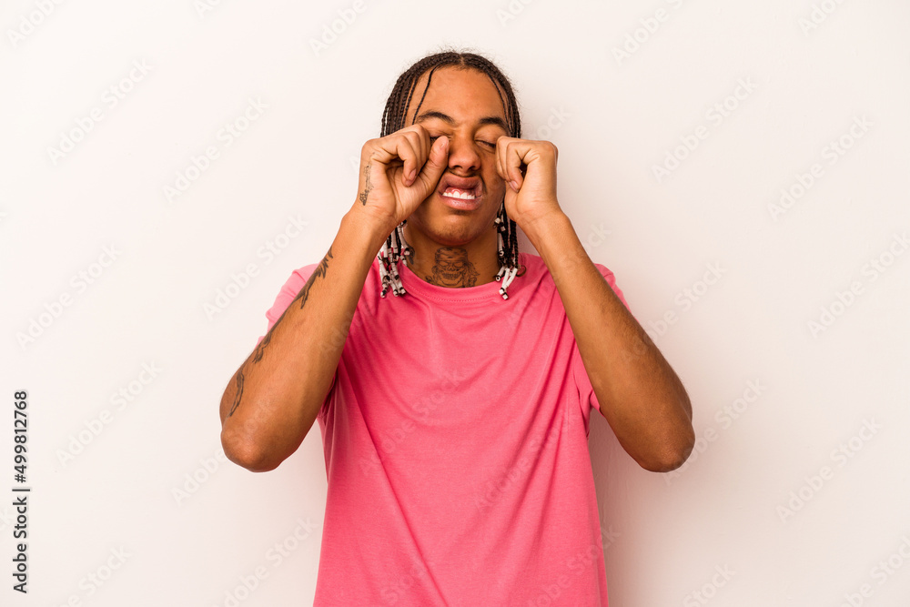 Young African American man isolated on white background whining and crying disconsolately. Young African American man isolated on white background whining and crying disconsolately.