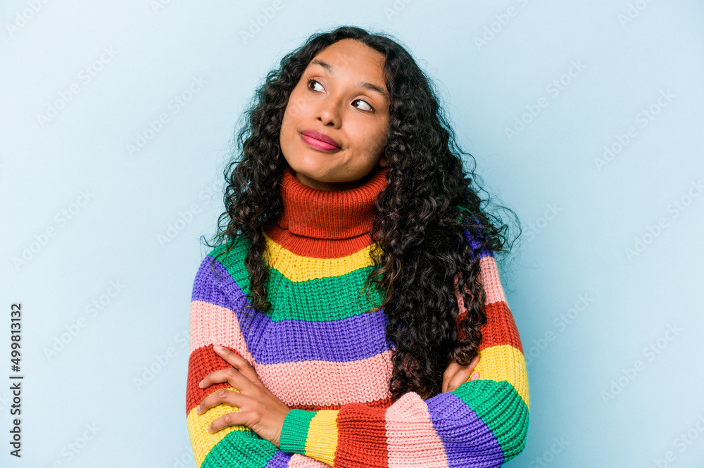 Young hispanic woman isolated on blue background dreaming of achieving goals and purposes Young hispanic woman isolated on blue background dreaming of achieving goals and purposes