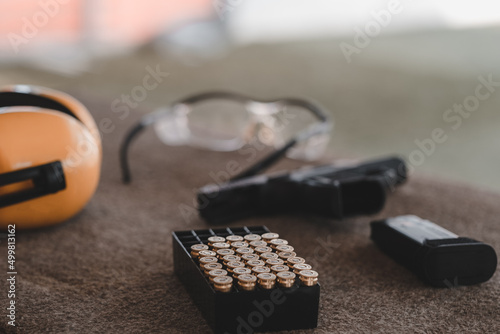 The sniper is preparing to hit the target. Guns and shooting equipment in the shooting range