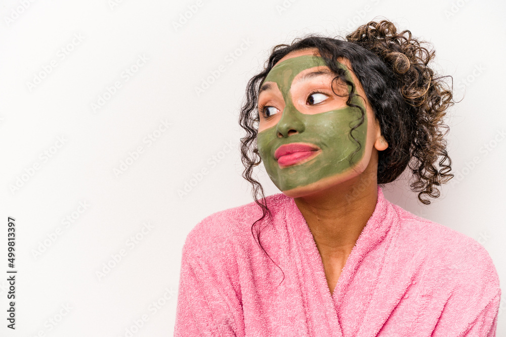 Young hispanic woman wearing a facial mask isolated on white background Young hispanic woman wearing a facial mask isolated on white background