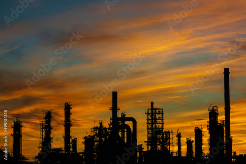 Silhouette of gas distillation of tank oil refinery plant tower oil of Petrochemistry industry on sky sunset