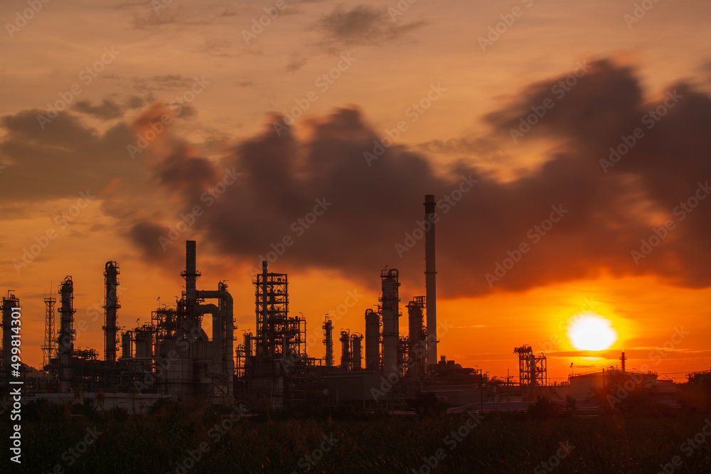 Oil​ refinery​ and​  plant and tower column of Petrochemistry industry in pipeline oil​ and​ gas​ ​industrial with​ cloud​ slowing red sky