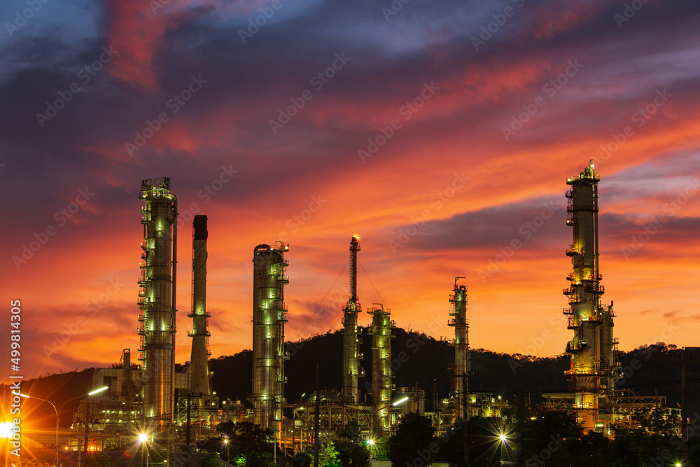 Oil refinery and plant and tower column of Petrochemistry industry in oil and gas industrial with cloud red sky the evening sunset Oil refinery and plant and tower column of Petrochemistry industry in oil and gas industrial with cloud red sky the evening sunset