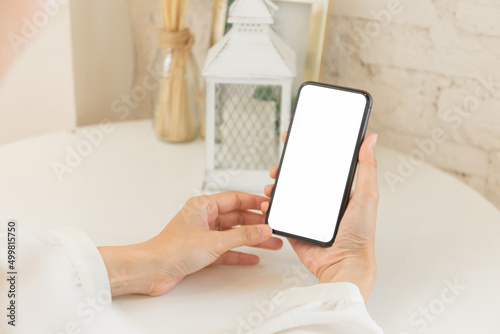 cell phone blank white screen mockup.hand holding texting using mobile on desk at office.background empty space for advertise.work people contact marketing business,technology