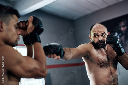 All it takes is the perfect punch. Cropped shot of two male fighters training at the gym. © Lyndon S/peopleimages.com