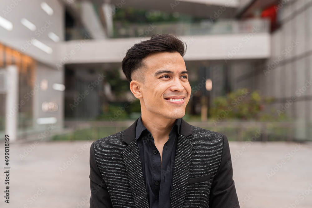 Obraz premium Portrait of handsome young businessman smiling and thinking