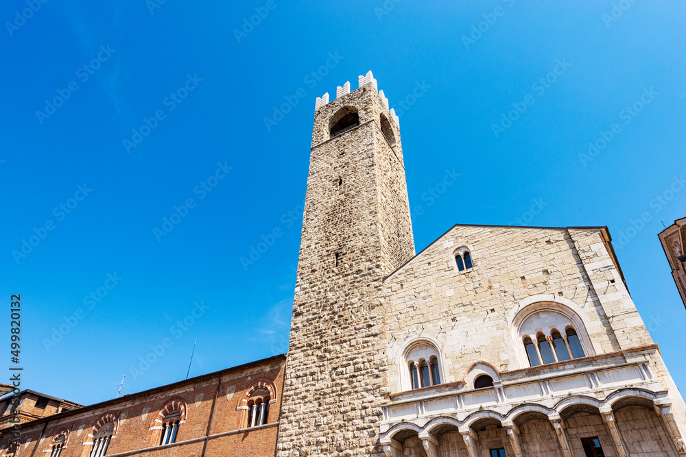 Brescia. Medieval Broletto Palace (Palazzo Broletto), XII-XXI century, with the ancient tower (Torre del Popolo o del Pegol) and the Loggia of Cries (Loggia delle Grida). Lombardy, Italy, Europe.