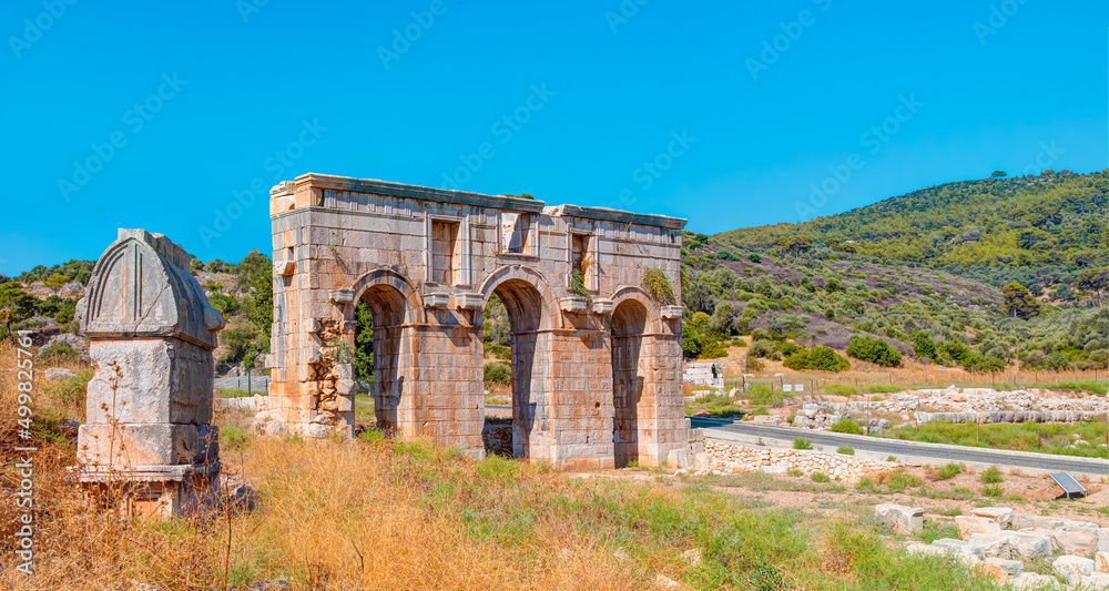 Ancient ruins of gates in Patara - Arch of Modestus in ancient Lycian city Patara - Kas, Antalya, Turkey.