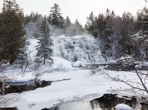 Frozen winter waterfall on river