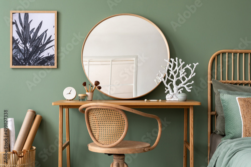 Fotobehang Stylish composition of bedroom in modern interior design with vanity table, big rounded mirror, tropical bed and beautiful personal accessories
