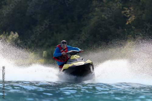 An extreme guy rides a sports jet ski on a mountain river. entertainment on a high-speed boat on the water with big splashes. Summer tourism and recreation on the water © Wlad Go