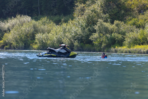 the rider fell from a jet ski and drowns in a mountain lake far from his transport. Summer tourism and recreation on the water. To advertise life jackets on reservoirs
