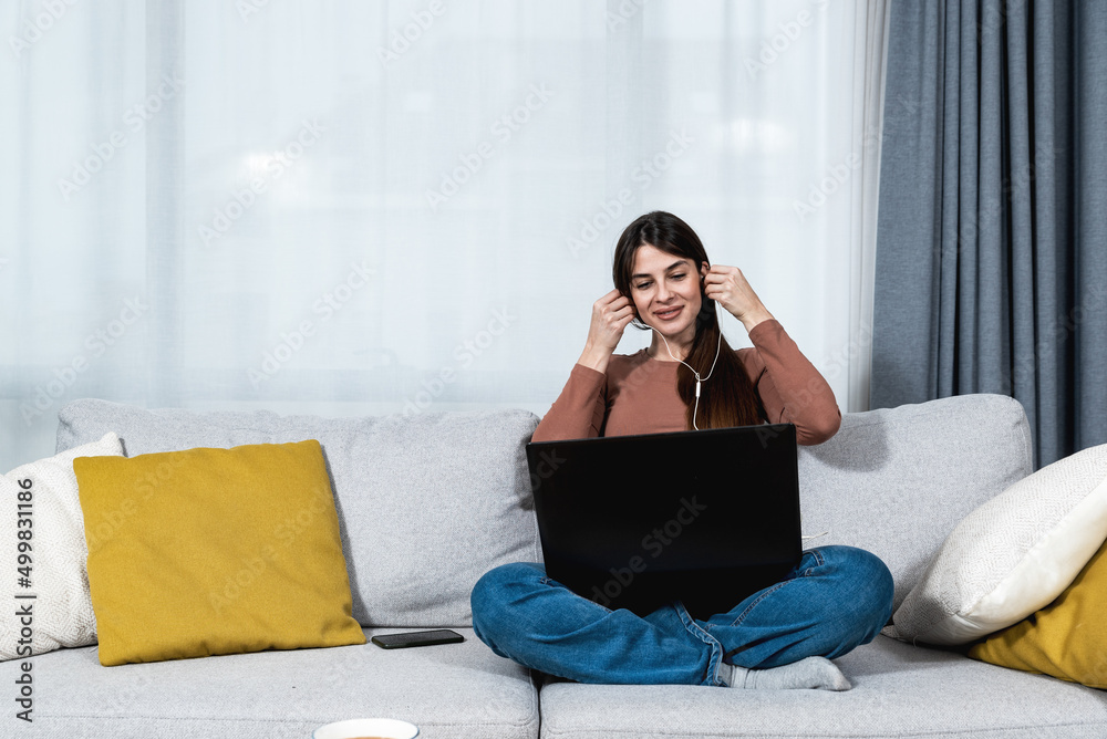 Young sick college student woman sitting at home and preparing for online class over the video conference call on her laptop computer. Online internet business education, health care concept. Young sick college student woman sitting at home and preparing for online class over the video conference call on her laptop computer. Online internet business education, health care concept.