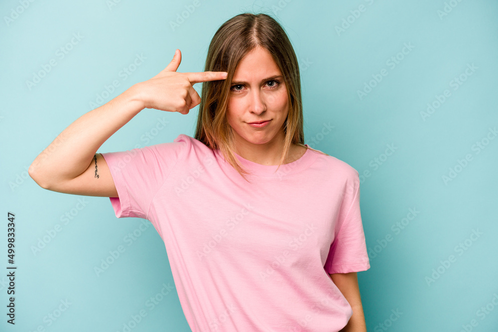 Young caucasian woman isolated on blue background showing a disappointment gesture with forefinger. Young caucasian woman isolated on blue background showing a disappointment gesture with forefinger.