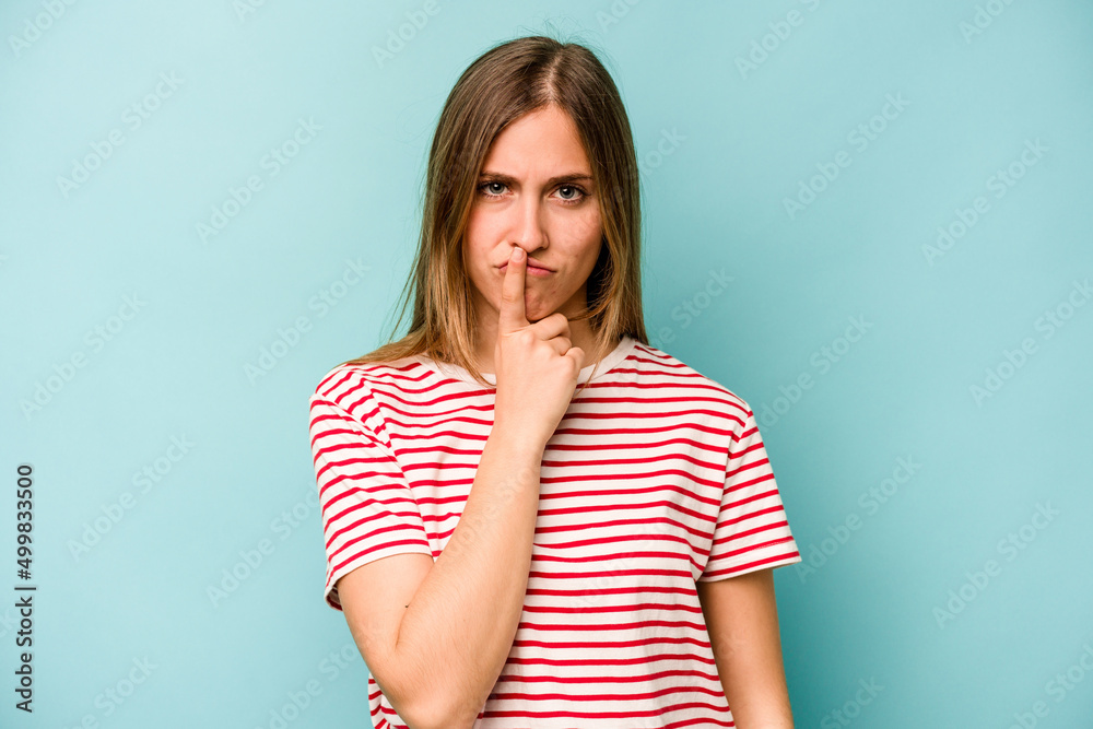 Young caucasian woman isolated on blue background thinking and looking up, being reflective, contemplating, having a fantasy. Young caucasian woman isolated on blue background thinking and looking up, being reflective, contemplating, having a fantasy.