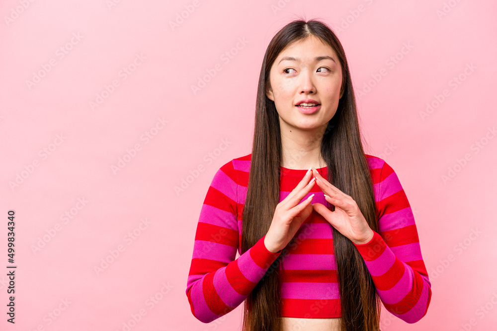 Young Chinese woman isolated on pink background making up plan in mind, setting up an idea. Young Chinese woman isolated on pink background making up plan in mind, setting up an idea.