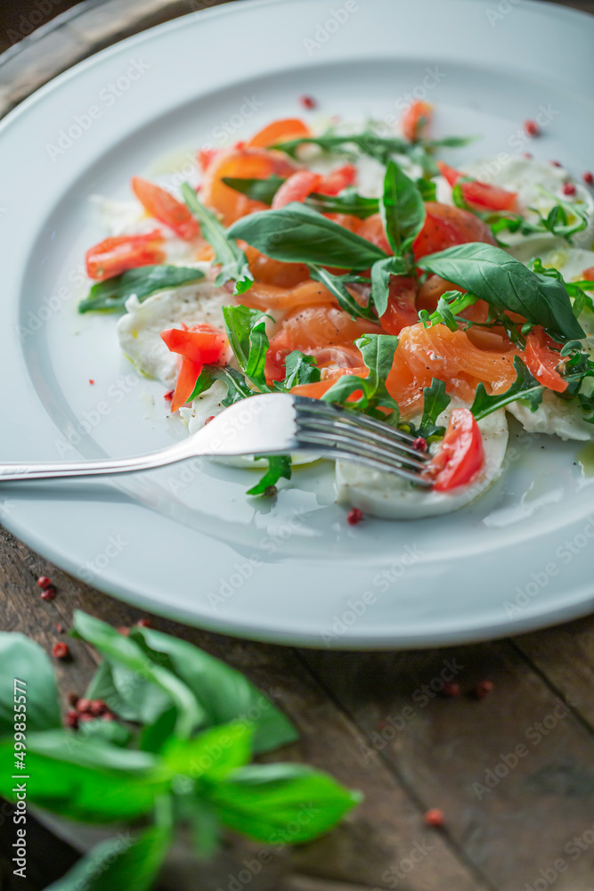 Mozzarella Salmon Salad on wooden Table Mozzarella Salmon Salad on wooden Table