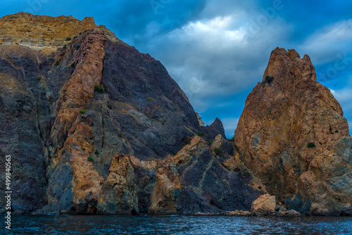 rocks of Cape Fiolent against the background of the evening sky with clouds