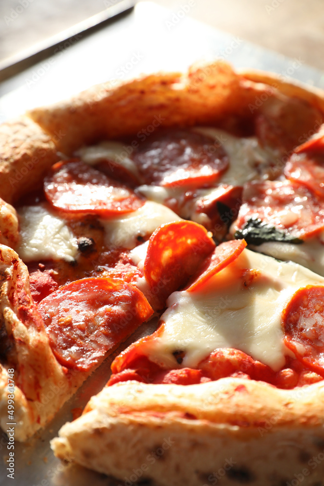 Sliced juicy Neapolitan pepperoni pizza with sausage Sliced juicy Neapolitan pepperoni pizza with sausage