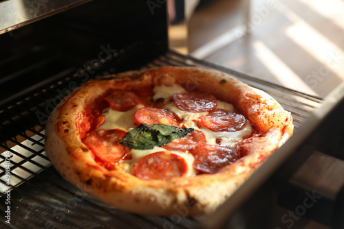 Neapolitan pepperoni pizza in the oven