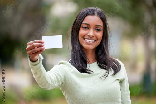 Life doesnt come with a free pass but theres always student cards. Shot of a young woman holding a blank card outside at college. © Beaunitta V W/peopleimages.com