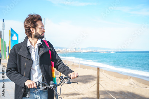Gay with bicycle on shore