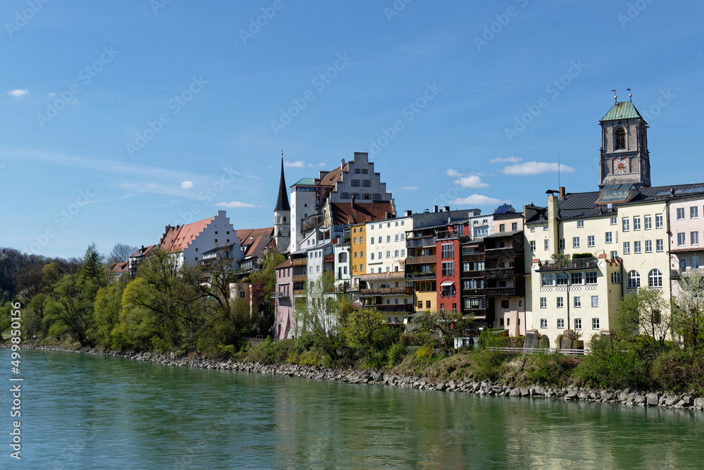 City view of Wasserburg am Inn. Colorful house facades on the banks of the Inn River.