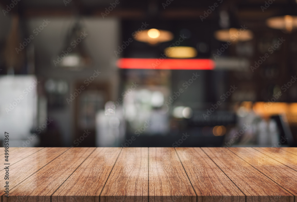 Empty wooden table top with lights bokeh on blur restaurant background. Empty wooden table top with lights bokeh on blur restaurant background.