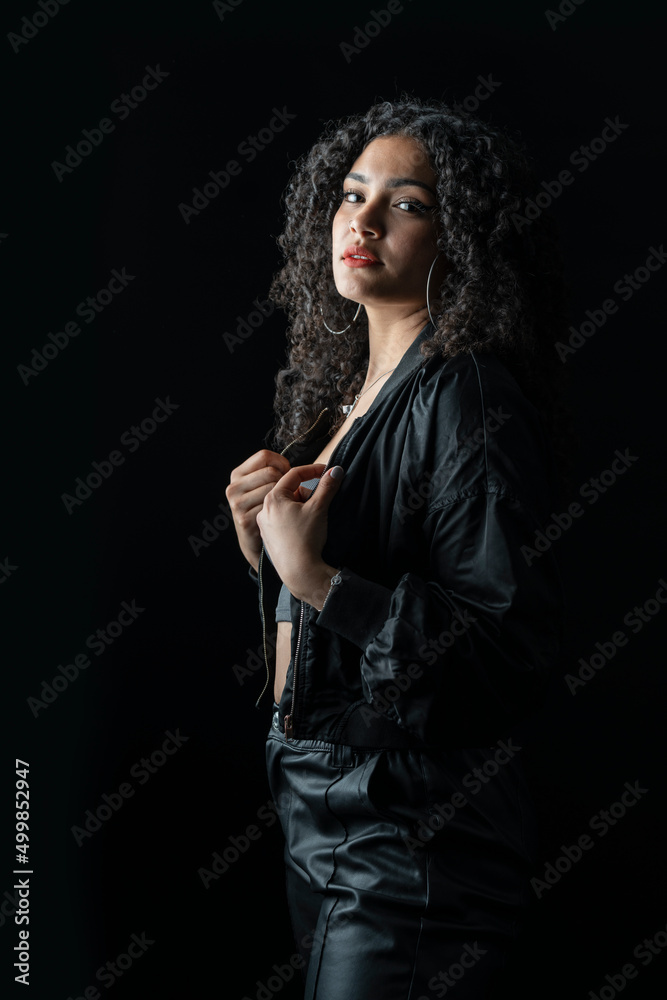 Portrait of a young colombian woman in studio with black background Portrait of a young colombian woman in studio with black background