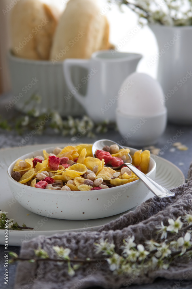 bowl with healthy muesli breakfast on table near spring blossoms branches bowl with healthy muesli breakfast on table near spring blossoms branches