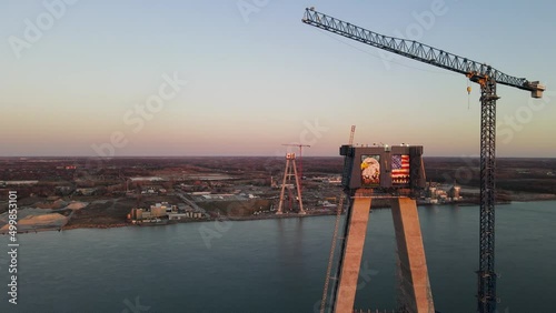 Flying around Suspension tower of Gordie Howe brigde during evening sun, Orbit drone shot, Detroit - Michigan. photo