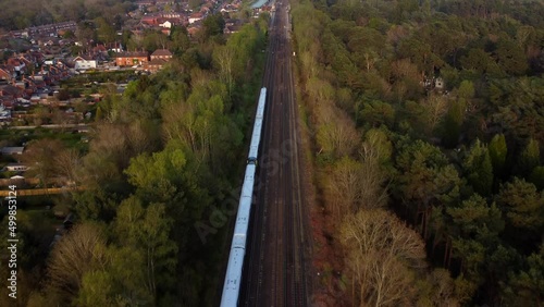 Aerial view train travelling through English countryside on sunny day photo
