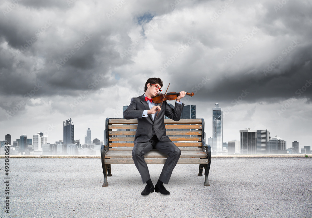 Young businessman plays the violin Young businessman plays the violin