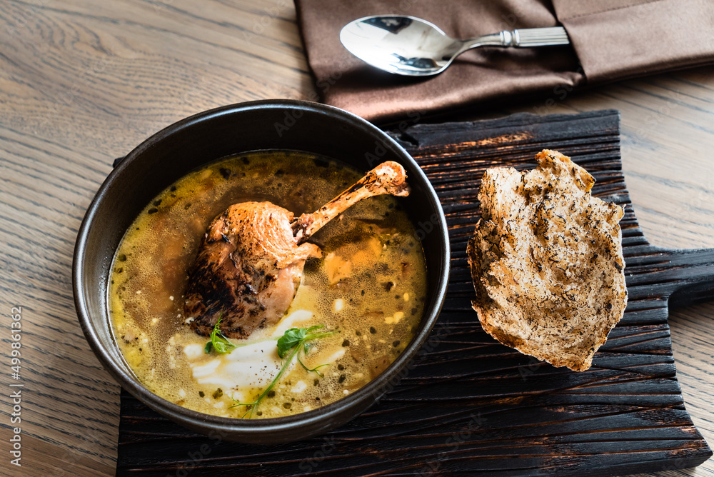 soup with duck on wooden board soup with duck on wooden board