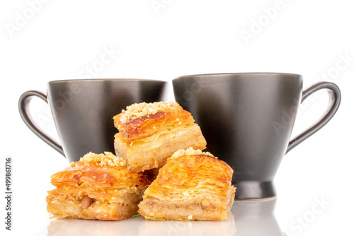 Sweet baklava classic with ceramic dishes  macro  isolated on a white background.