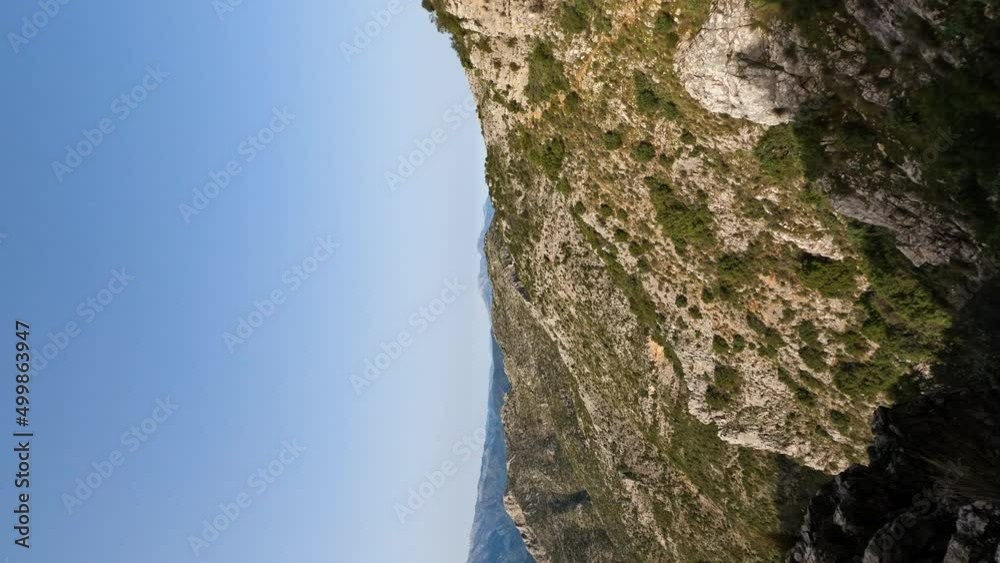 4k Vertical shot of hikers walking on the side of a mountain cliff. Epic adventure hiking landscape nature beauty at La Concha, Marbella, Spain. 4k Vertical shot of hikers walking on the side of a mountain cliff. Epic adventure hiking landscape nature beauty at La Concha, Marbella, Spain.