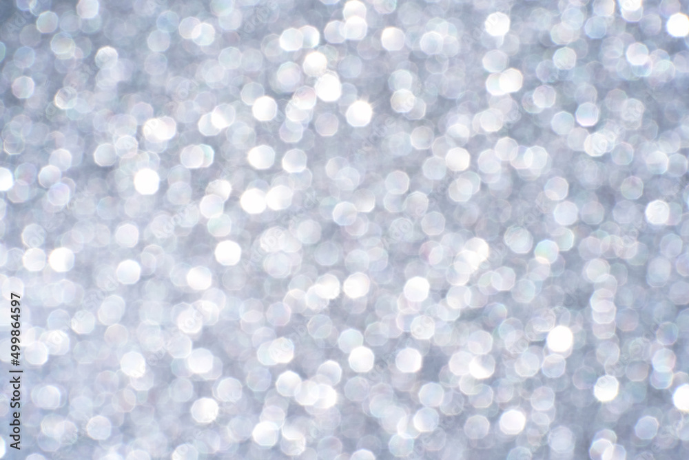 Bokeh circle with silver sparkles background. Grey glitter backdrop. Monochrome texture. New year luxury snow. Copyspace. Shimmer confetti wallpaper. Dreamy shiny design detail