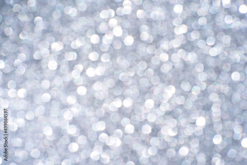 Bokeh circle with silver sparkles background. Grey glitter backdrop. Monochrome texture. New year luxury snow. Copyspace. Shimmer confetti wallpaper. Dreamy shiny design detail
