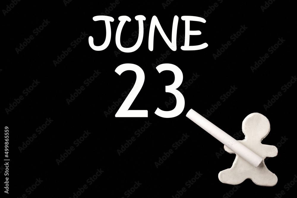 A small white plasticine man writing the date 23 June on a black board. Business concept. Education concept. A small white plasticine man writing the date 23 June on a black board. Business concept. Education concept.