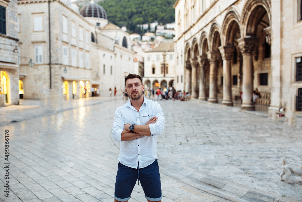 Handsome sexy man in white shirt in old european city. Summer in Croatia. Dubrovnik city