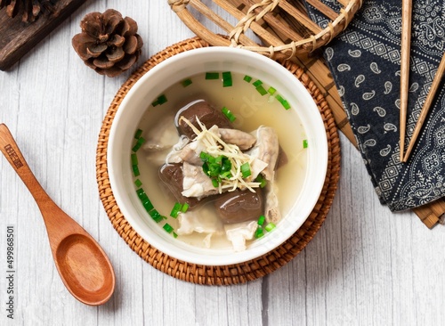 Powder sausage soup in a bowl with wooden spoon isolated on wood table side view taiwan food photo