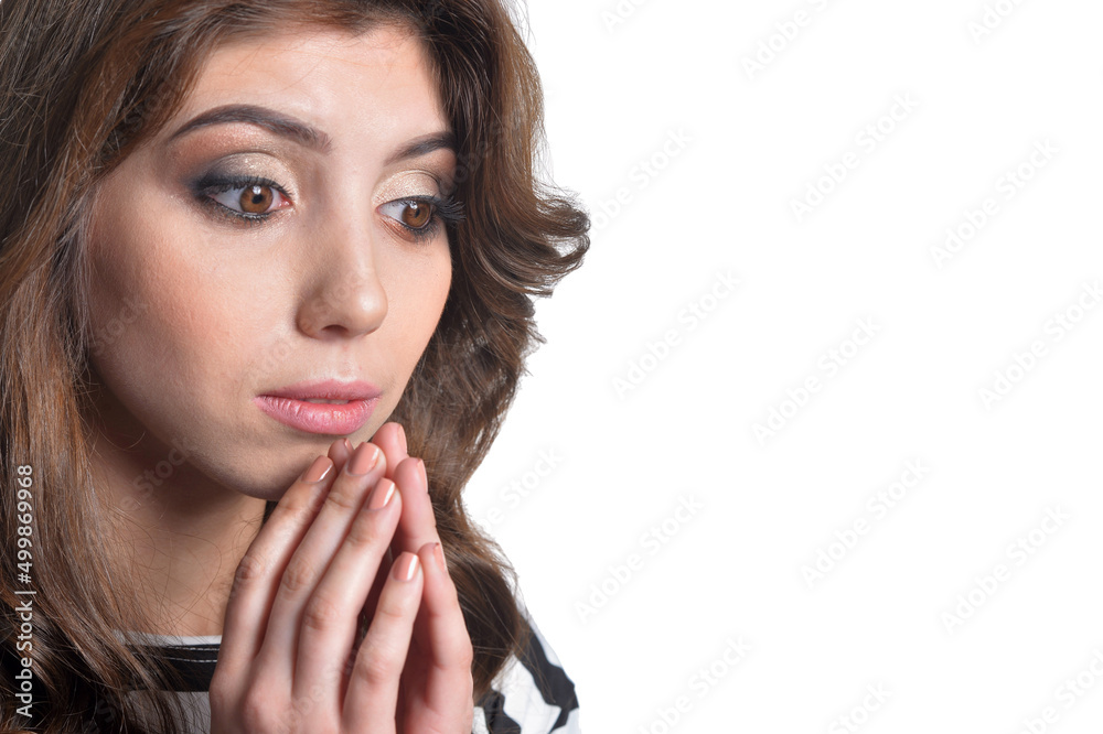 Close up portrait of beautiful brunette young woman praying on white background Close up portrait of beautiful brunette young woman praying on white background