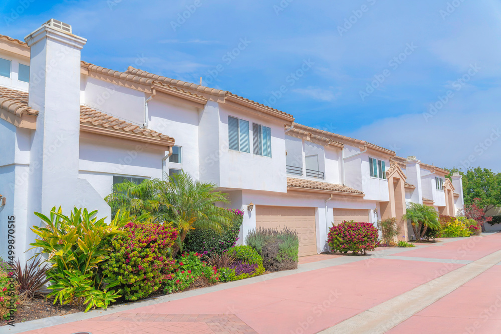 White townhouses exterior with landscape garden at the front at Carlsbad, San Diego, California